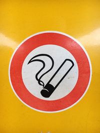 Close-up of smoking sign on yellow metal