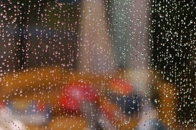 Full frame shot of raindrops on glass window