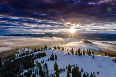 Scenic view of snowcapped mountains against sky during sunset