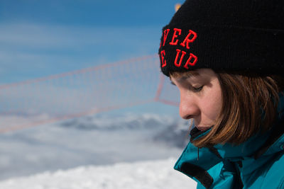 Woman wearing winter clothing in snowy mountains