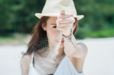 Portrait of woman holding sand 