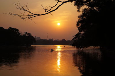 Scenic view of lake at sunset