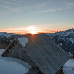 Scenic view of snowcapped mountains against sky during sunset