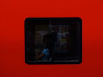 Close-up of man with red camera