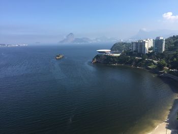 High angle view of sea and buildings against sky