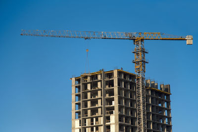 Low angle view of building against clear blue sky