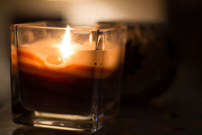 Close-up of illuminated tea light candle on table