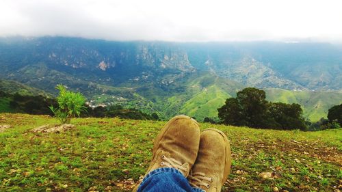 Low section of woman relaxing on mountain