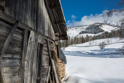 Wooden shack in winter day with fresh snow in the mountains.