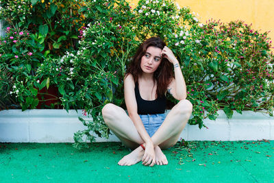 Thoughtful woman sitting alone outdoors. young worried in backyard