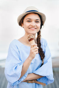 Portrait of smiling woman holding ice cream