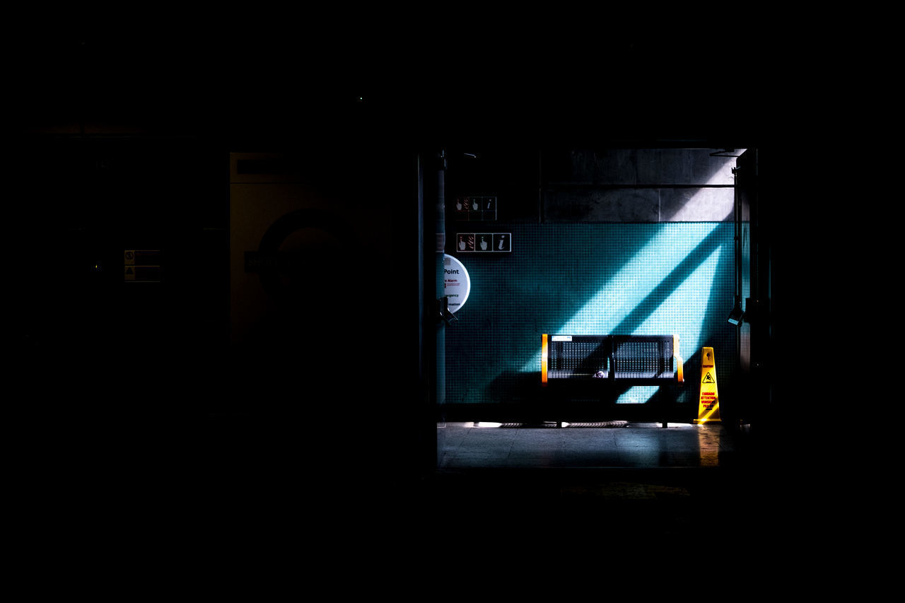 VIEW OF ILLUMINATED TRAIN IN DARK ROOM