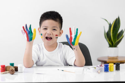 Portrait of boy sitting on table