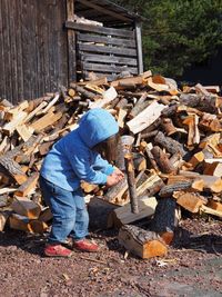 Girl carrying log