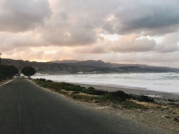 Road by sea against sky