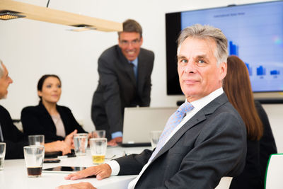Portrait of a man with woman standing in office