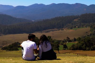 Rear view of couple looking at mountains