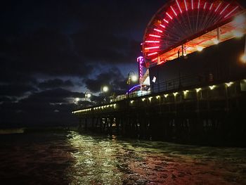 Illuminated bridge at night