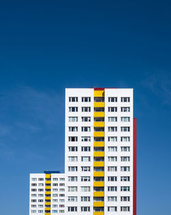 Low angle view of buildings against clear blue sky