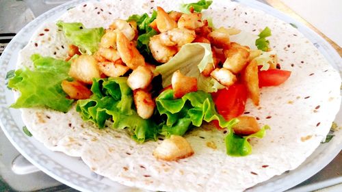 Close-up of meat and salad on tortilla