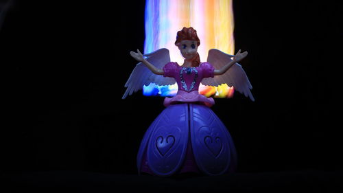 Multi colored statue against black background
