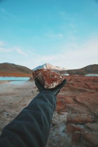 Close-up of human hand holding rock