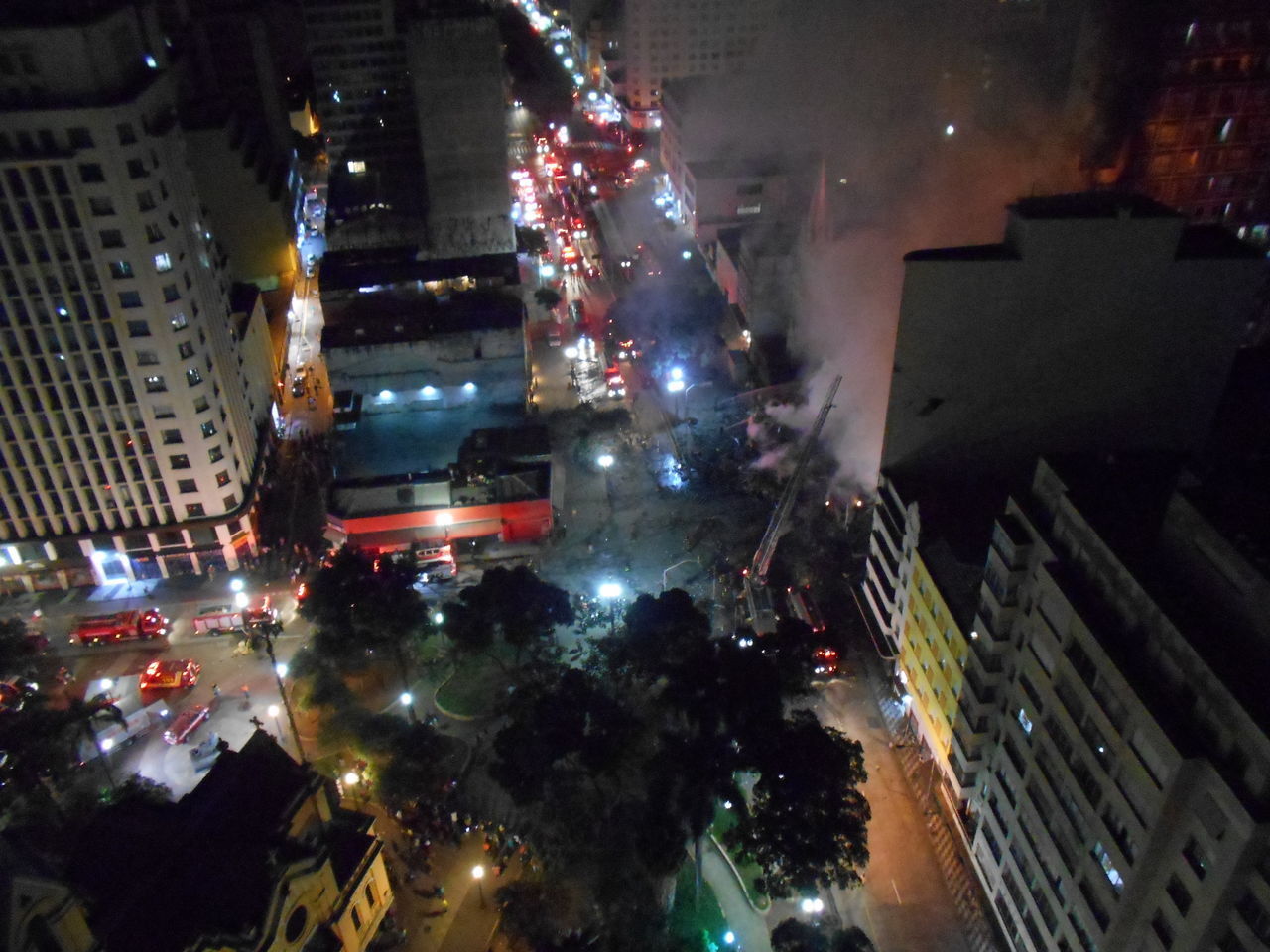 HIGH ANGLE VIEW OF ILLUMINATED BUILDINGS AT NIGHT