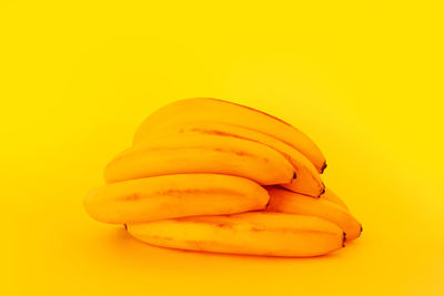 Close-up of orange slice over yellow background