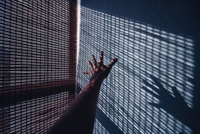 Shadow of person hand on tiled floor