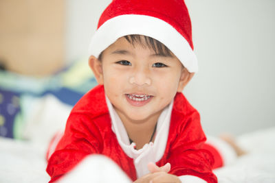 Thai boy in red santa claus outfit smiling happily happy christmas day.