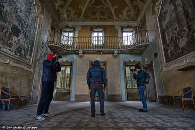 Low angle view of people standing in corridor