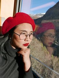 Portrait of young woman wearing hat