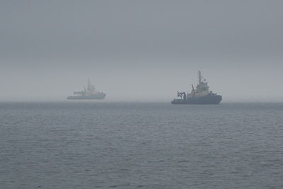 Ship sailing on sea against sky