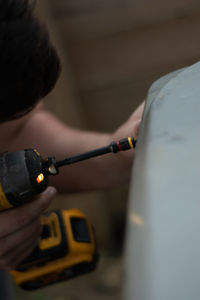 Close-up of man repairing car