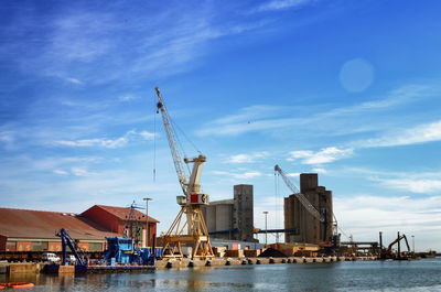 Commercial dock by sea against sky