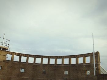 Low angle view of built structure against cloudy sky