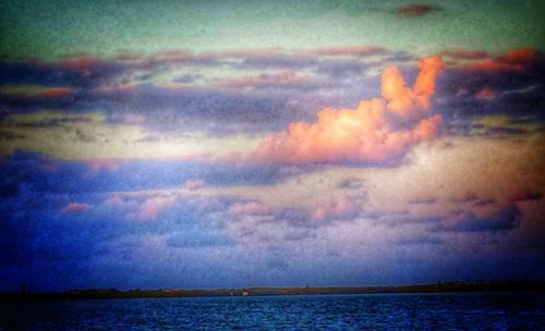 Scenic view of sea against cloudy sky