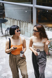 Young woman wearing sunglasses standing outdoors