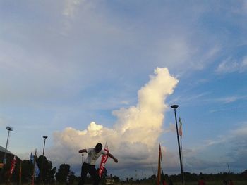 Rear view of man standing against sky