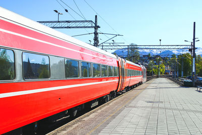 Train at railroad station platform against sky