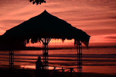 Silhouette person on beach during sunset