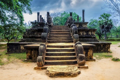 Exterior of temple by building against sky