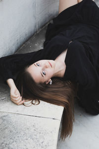 Portrait of woman lying down on floor