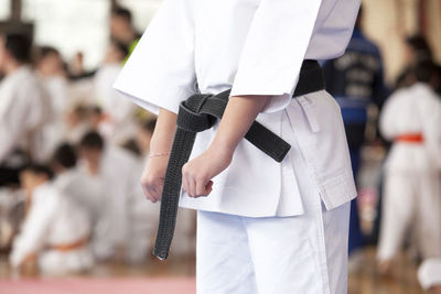 Midsection of women practicing karate