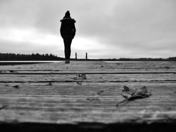 Teenage girl standing on boardwalk