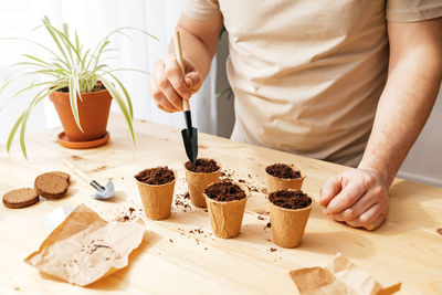 Midsection of man preparing food on table