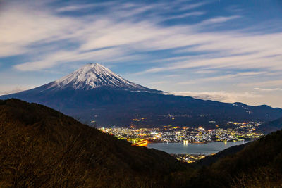 Night clouds moving behind mount fuji at kawaguchigo, japan