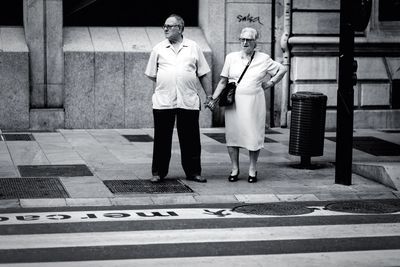 Full length of woman standing by railing