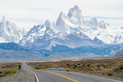 Empty road against fitz roy mountains during winter