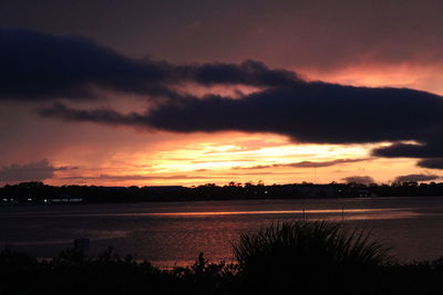 Scenic view of lake against romantic sky at sunset